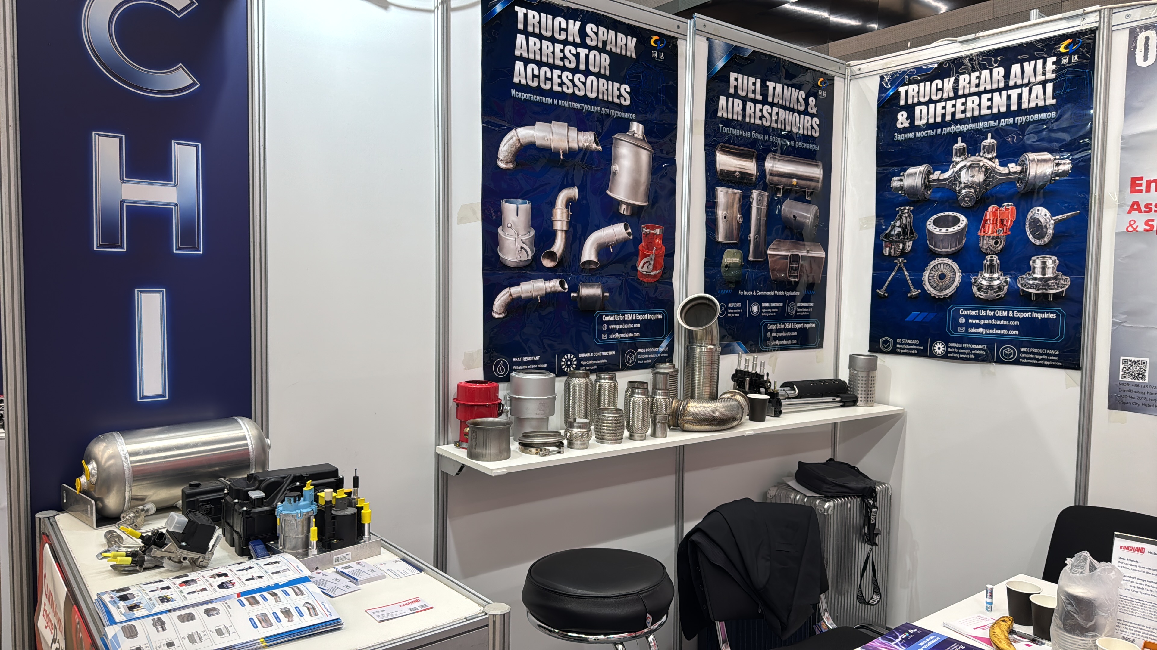 Hubei Guanda Automobile booth displays featuring SCR aftertreatment dosing units, spark arrestors, and aluminum air reservoirs