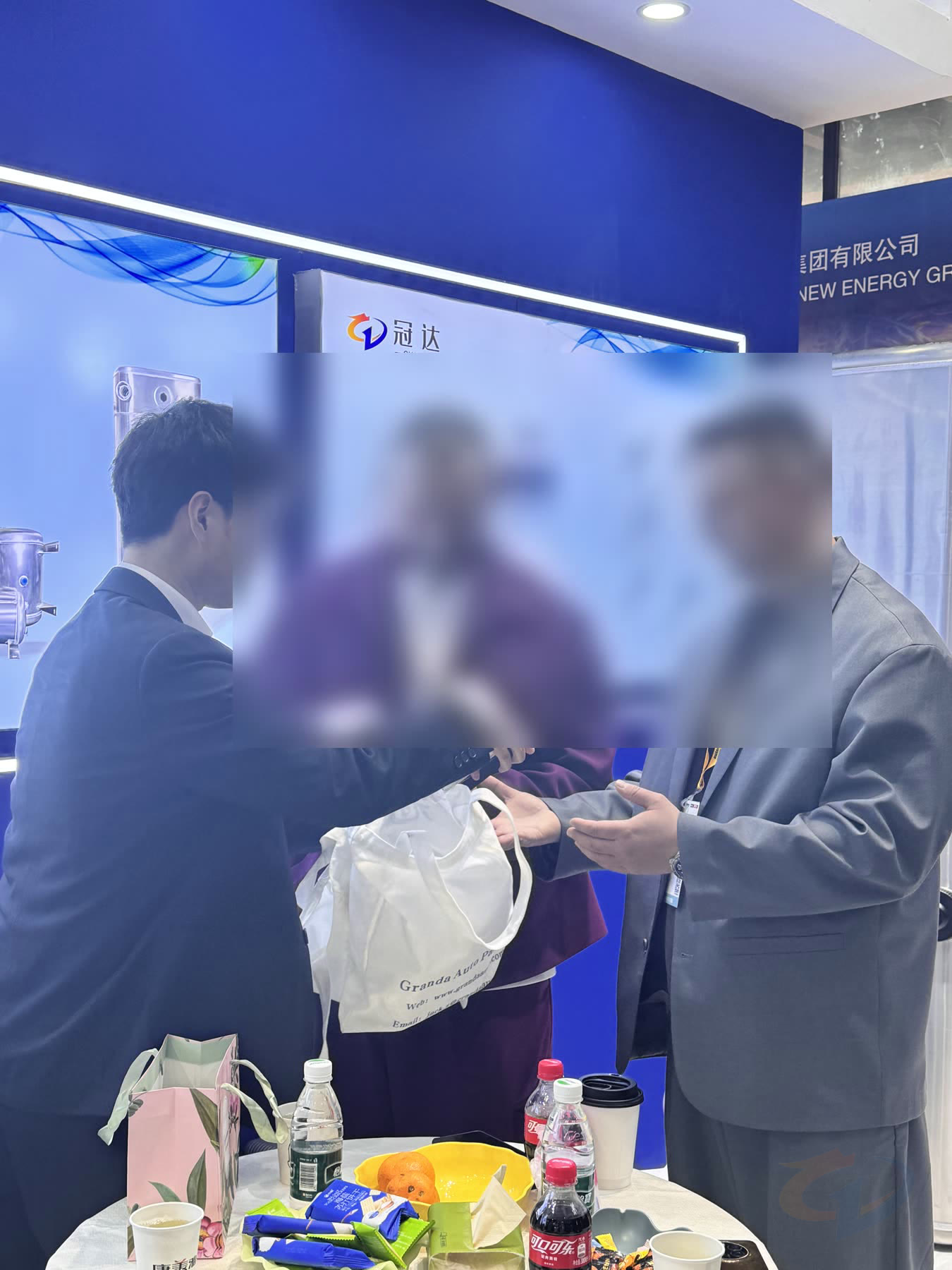 Guanda representative sharing materials with customers during an exhibition meeting
